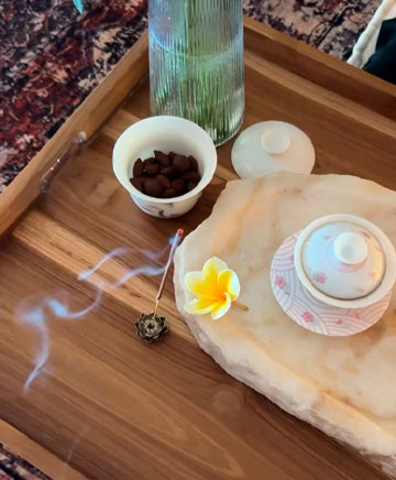 Tea ceremony setup with incense and natural elements in a Bali spa ritual